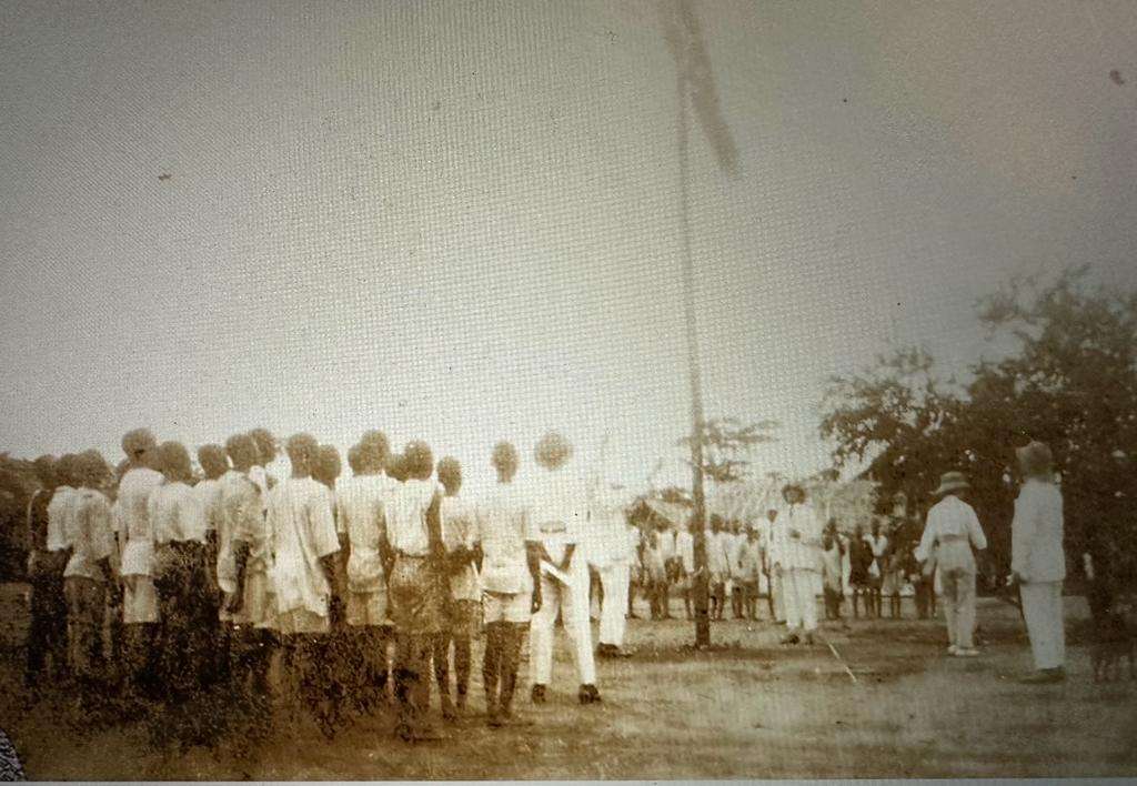 Unfurling of a flag at a sports day at Uzuakoli mission station
